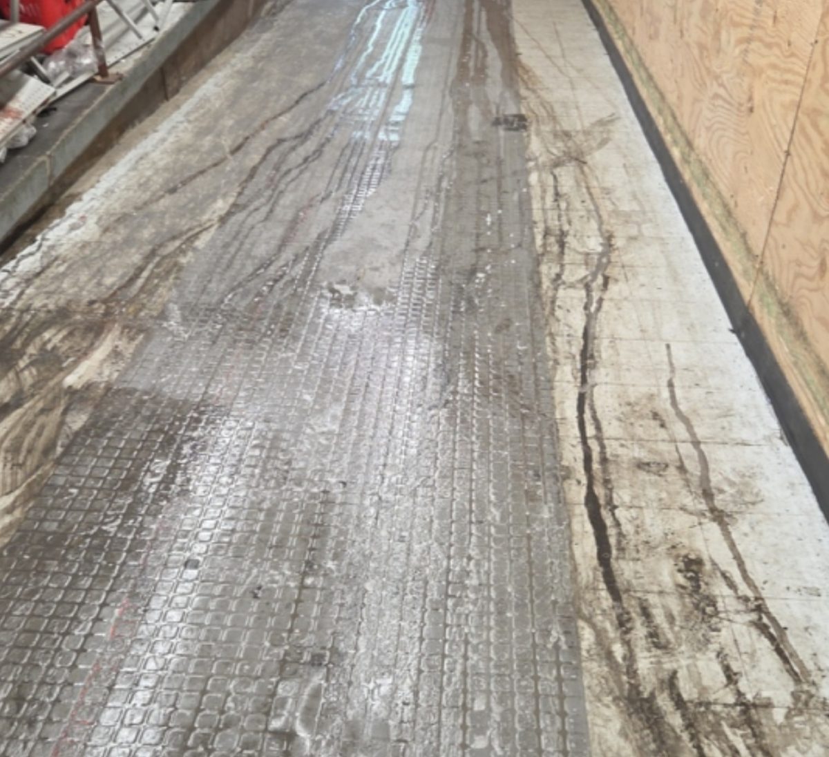 Before: Filthy, worn back-of-house ramp floor streaked with grime